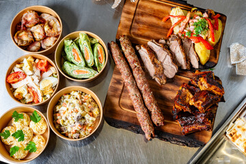 Delicious spread of grilled meats and fresh salads in a festive setting