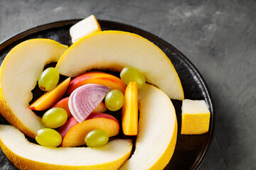 Fresh Fruits and Vegetables on Black Plate, Vegetarian Food Concept, Close-Up