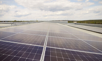 Close up shot of a solar panels, installed on the roof of a building. The photovoltaic equipment generates renewable energy, contributing to eco friendly electricity production and power. © Studio Romantic