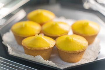 A delectable display of freshly baked egg tarts, their golden, flaky crusts perfectly complementing...