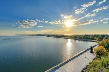 Obraz premium Serene sunset over a calm river with a scenic shoreline and vibrant foliage