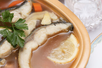 Carp in jelly – traditional Christmas dish of Eastern Europe. Classic holiday delicacy on the festive table. Christmas Eve food celebrated in Polish and Eastern European cultures. One of twelve dishes