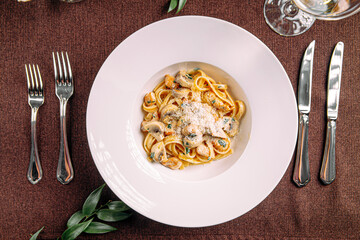 Portion of fettuccine alfredo pasta with mushrooms and chicken