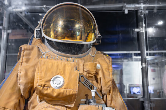Working spacesuit against technology background
