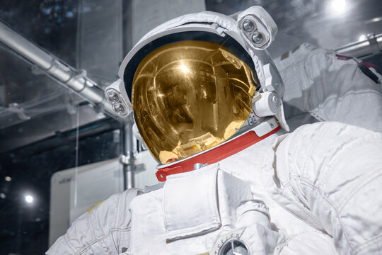 Working spacesuit against technology background