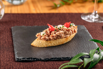 Portion of gourmet bruschetta with tuna and garlic
