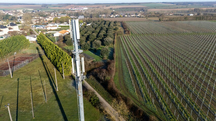 5G Communication Tower by Vineyard and Village Landscape