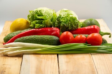 composition with raw fresh vegetables on wooden board