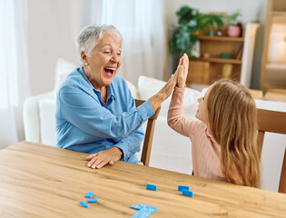 grandchild family child grandparent grandmother granddaughter girl game playing board board game...