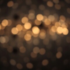 Abstract blurred golden bokeh lights on dark background.