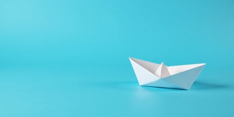 A solitary paper boat floats serenely on a vibrant blue background, symbolizing dreams, adventures, and the boundless possibilities that lie ahead.