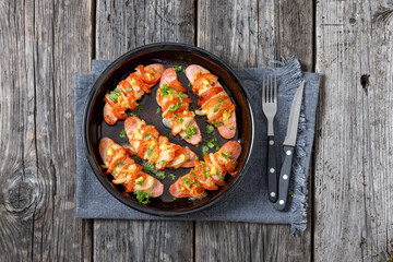 hot sausages baked with cheese, tomato, mustard