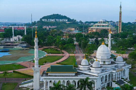Batam skyline with "Welcome to Batam" text. Cityscape from a window. Batam, a bustling industrial hub, is the largest city in the Riau Islands, known for its vibrant urban landscape.