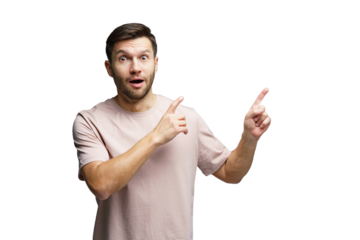 Surprised man pointing in opposite directions with an astonished expression indoors