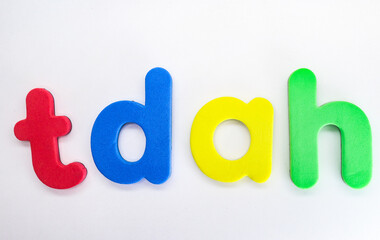 Attention Deficit Hyperactivity Disorder abbreviation. Spanish acronym TDAH with colorful letters on white background