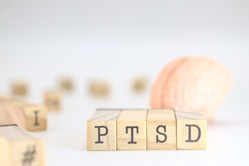 Post Traumatic Stress Disorder abbreviation. PTSD acronym written on wooden cubes isolated on white background with space for text.