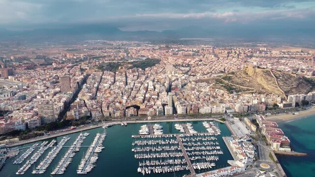 Aerial view of Alicante city. View of Marina of Alicante and promenade area. Panoramic view of all city. At right, on top of the hill, is Santa Barbara Castle. Famous travel destination. Forward.