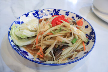 Papaya salad with fermented fish and crab is a popular street Thai food, known for its hot and...