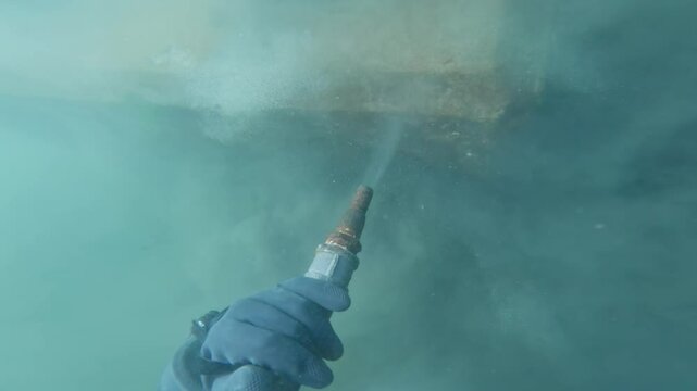 Commercial diver conducting underwater dredging