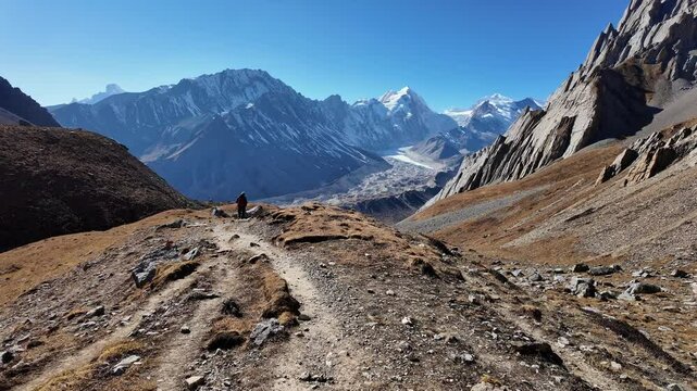 Manaslu Circuit, Nepal: Point of view of a trekker hiking back from the Chinese Tibet border pass at the Rui La pass, near Samdo village on a clear winter day in the Himalaya in Nepal. 