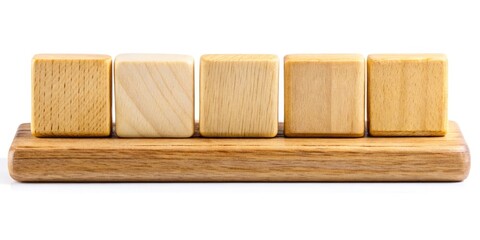 Macro Photography of Five Blank Scrabble Tiles on a Wooden Rack Against a White Background