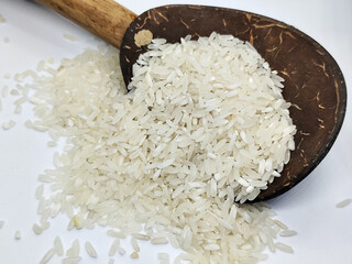 Unprocessed rice, on a natural blurred white background.