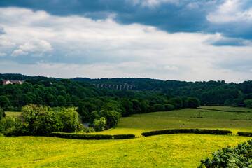 Lush Green Countryside and the Iconic  Viaduct Framed by Rolling Hills and Dramatic Skies 