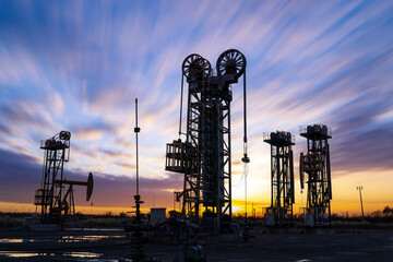 In the evening, oil pumps are running, Silhouette of beam pumping unit