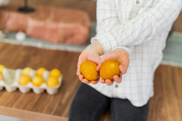 The boy is holding Easter eggs in his hands. The concept of Easter, Christianity, family