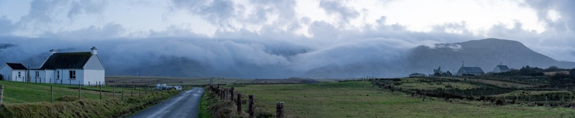 Panorama. View of mountains in the fog and a Assaranca waterfall. Donegal, Ardara. 