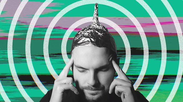 Man with tin foil hat concentrating on colorful backgrounds
