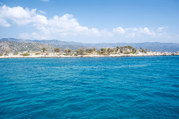 Fototapeta premium Beautiful bay near Kekova island and Kas in Antalya province, Turkiye. Sunny summer in seaside. Turquoise water.