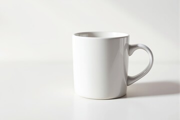 Obraz premium Minimalist white mug on a clean, light background with soft shadows for branding or product presentation.
