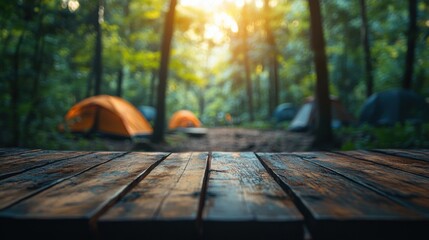 Rustic wooden table in the foreground and blurred forest campsite in the background create a summer outdoor scene for product display or advertising design montage template
