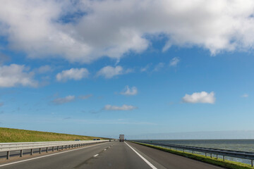Drivers perspective over A7 road between Friesland and North Holland provinces in the Netherlands over the Afsluitdijk (dam separates IJsselmeer lake from Wadden Sea) built to protect against floods
