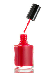 Red nail polish bottle with cap removed showcasing vibrant color and glossy finish