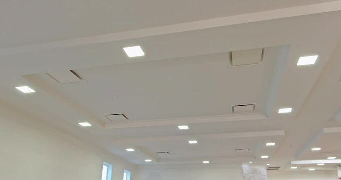 Bright indoor area featuring a contemporary ceiling layout with recessed lighting and air vents.