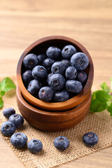 Blueberries in wooden bowl on wooden table, Healthy fruit, Food ingredient
