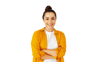 Confident young caucasian or arabian brunette woman, wearing a yellow shirt, standing with arms...