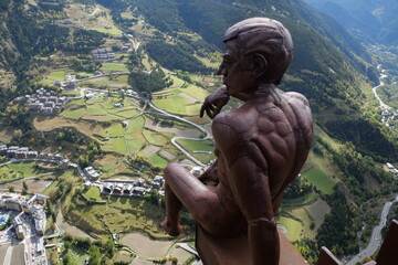 A majestic statue at Mirador del Roc del Quer overlooks a breathtaking mountainous landscape, set...