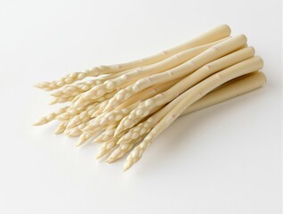 Bundle of uncooked white asparagus on a white table, unblemished, straight, long