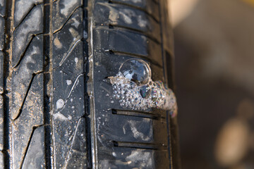 CloseUp View of Car Tire with Soap Bubbles