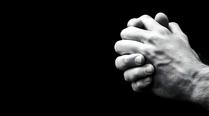 Hands clasped in prayer, black background, hope concept, faith, spirituality, religious imagery