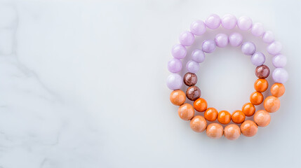 Pastel and orange bead bracelet on marble;  jewelry crafting;  lifestyle photography; website banner