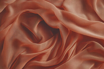 Obraz premium Transparent chiffon and silk fabric in brown or mocha mousse color. Light and airy waves, design template for trendy background, wallpaper and backdrops. Advertisement of sewing art and fashion