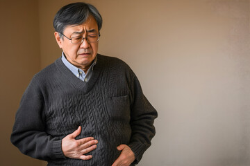 Asian elder man suffering from abdominal pain.
