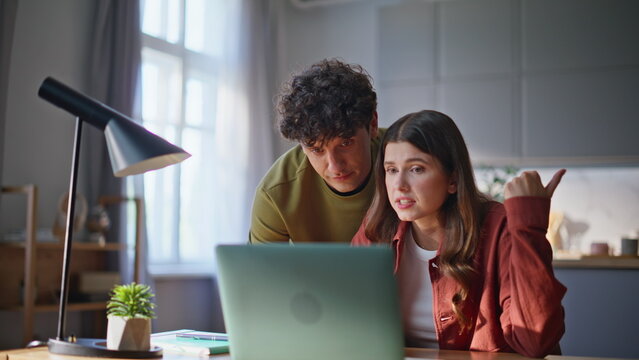 Worried family staring laptop communicating at modern house interior closeup - Powered by Adobe