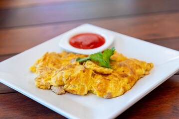 Omelet fried beaten eggs with minced pork chilly sauce,Thai traditional style eggs dish.