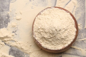 plate with protein powder on wooden background