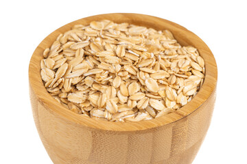 Bowl of rolled oats in a wooden container isolated on white, perfect for healthy eating and nutrition concepts.